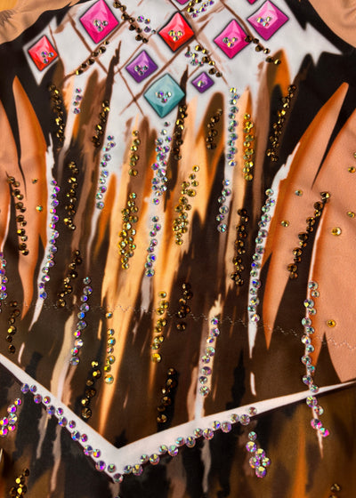 Close-up of beige and brown strokes, angular white lines and applied crystals.