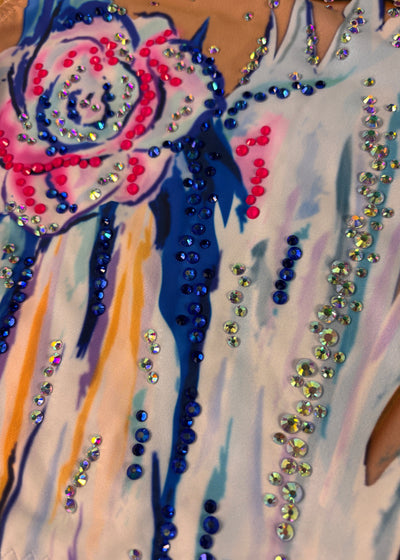 Detail of the pink-and-blue flower with blue strokes and iridescent embellishments.