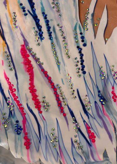 Close-up of the white-and-pale-blue hem with pink and blue strokes and sparkling embellishments.