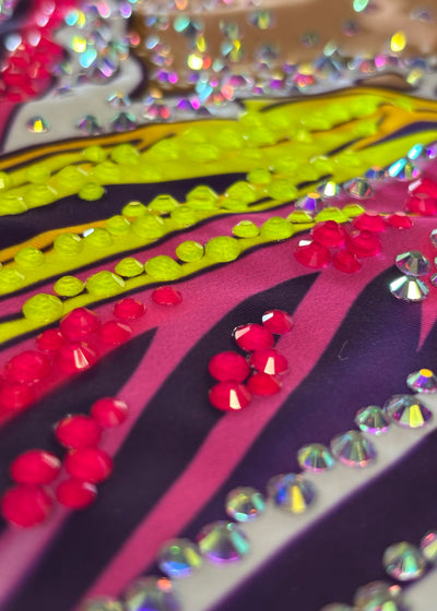 Sleeveless elastic rhythmic gymnastics leotard in vibrant violet with rhinestones.