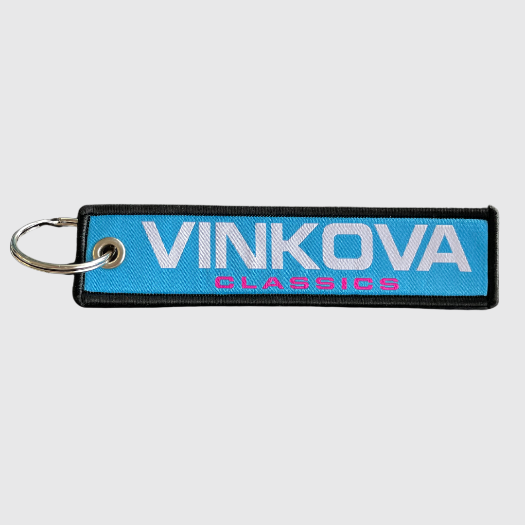 Vinkova keyring, colour: blue, with white logo and metal ring.