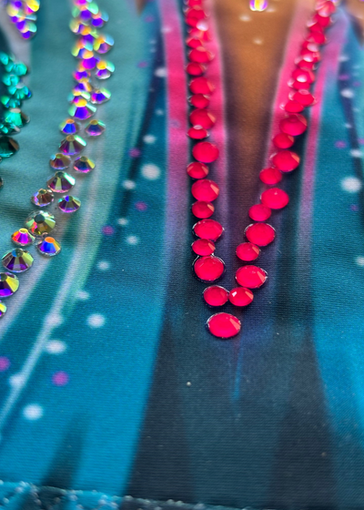 Cyan blue rhythmic gymnastics leotard with fuchsia gradient and sparkling rhinestone decoration on the chest.